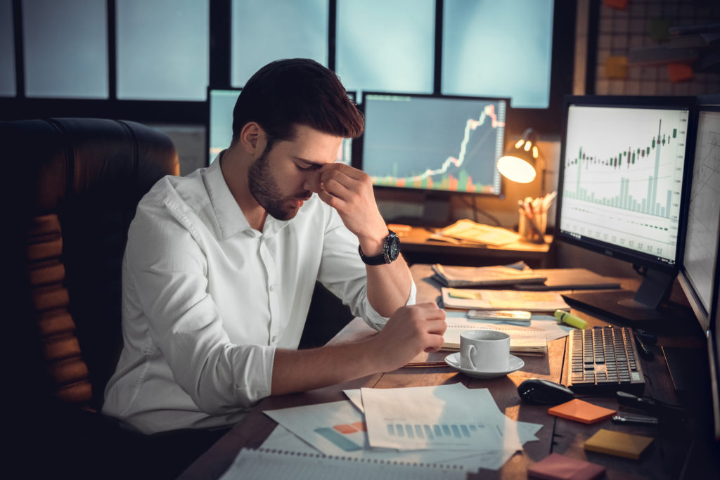 Depressed frustrated trader tired of overwork or stressed by bankruptcy, sad shocked investor desperate about financial crisis or money loss, upset businessman having headache massaging nose bridge